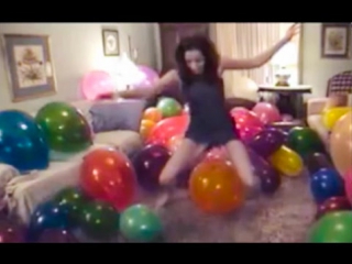 girl sit to pop big balloons balloon room